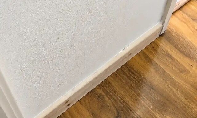 Close-up view of finished flooring with a neat skirting board edge