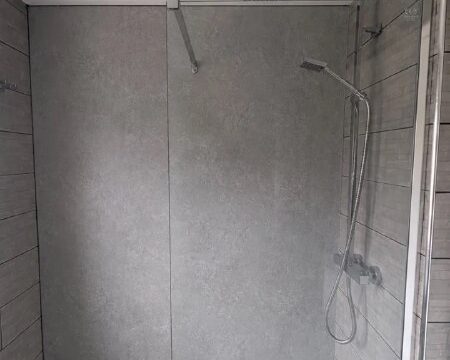 Completed shower wall repair in Newcastle with grey waterproof panels