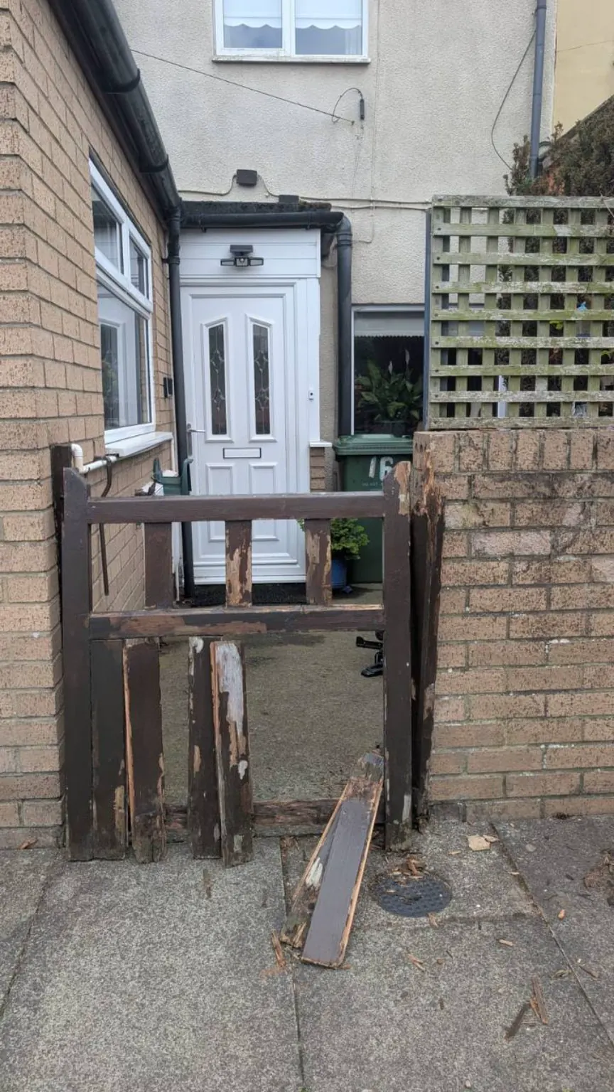 Rotten and broken wooden entrance gate before repair in Ryton