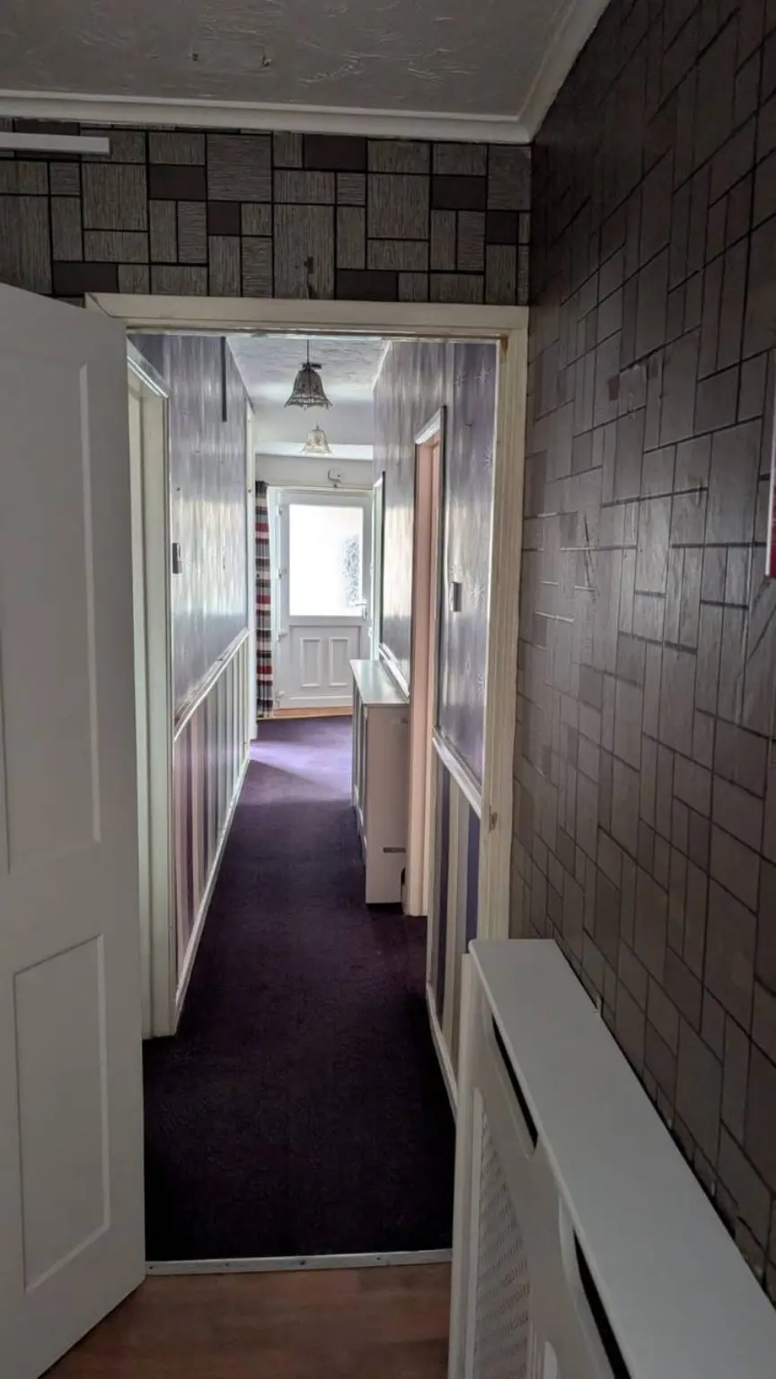 Dark patterned wallpaper before wall preparation in Walkergate