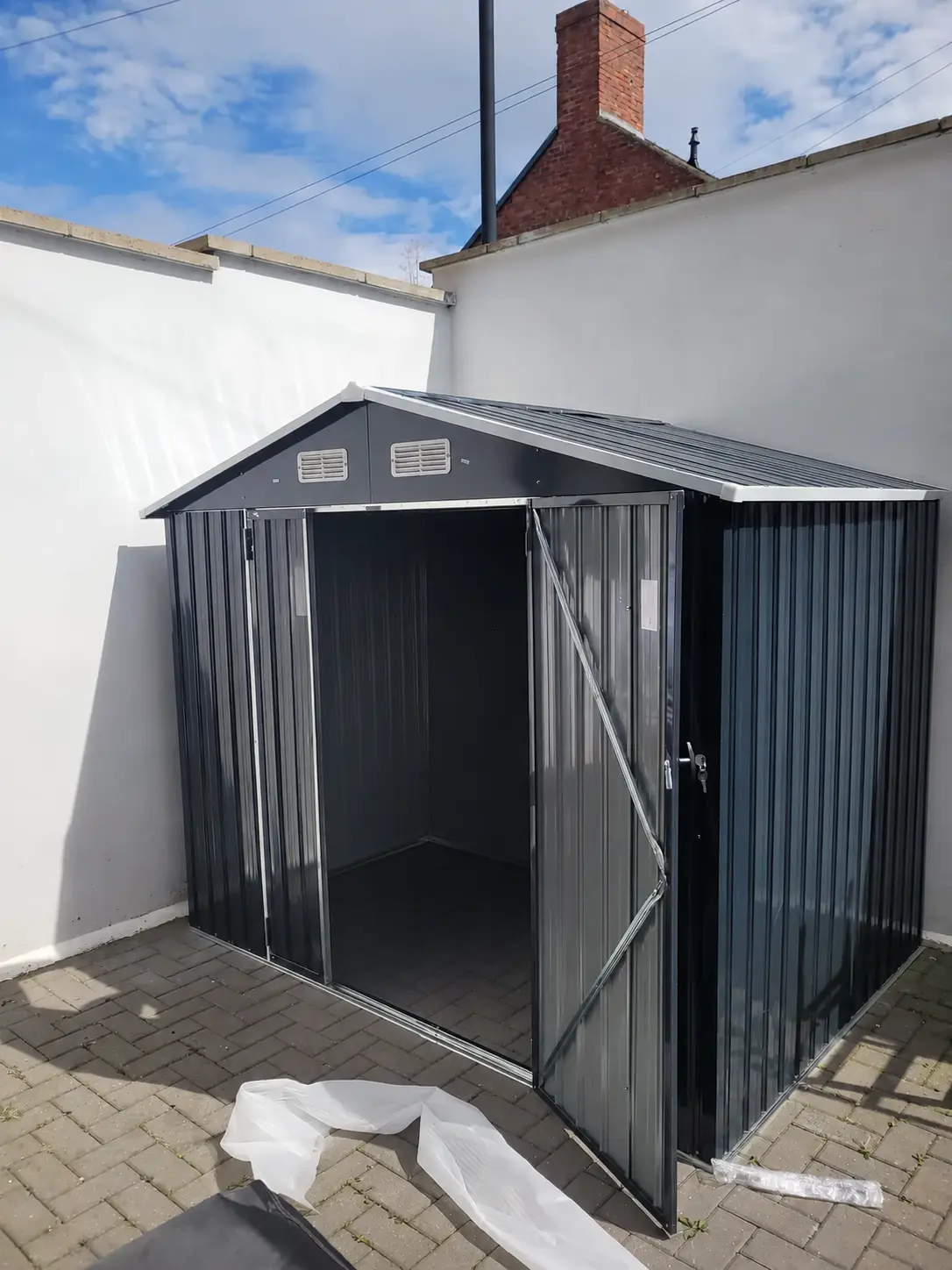 Dark grey metal garden shed completed in Newcastle