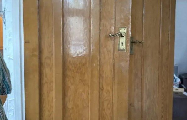 Wooden internal door with an older handle and lock in Newcastle