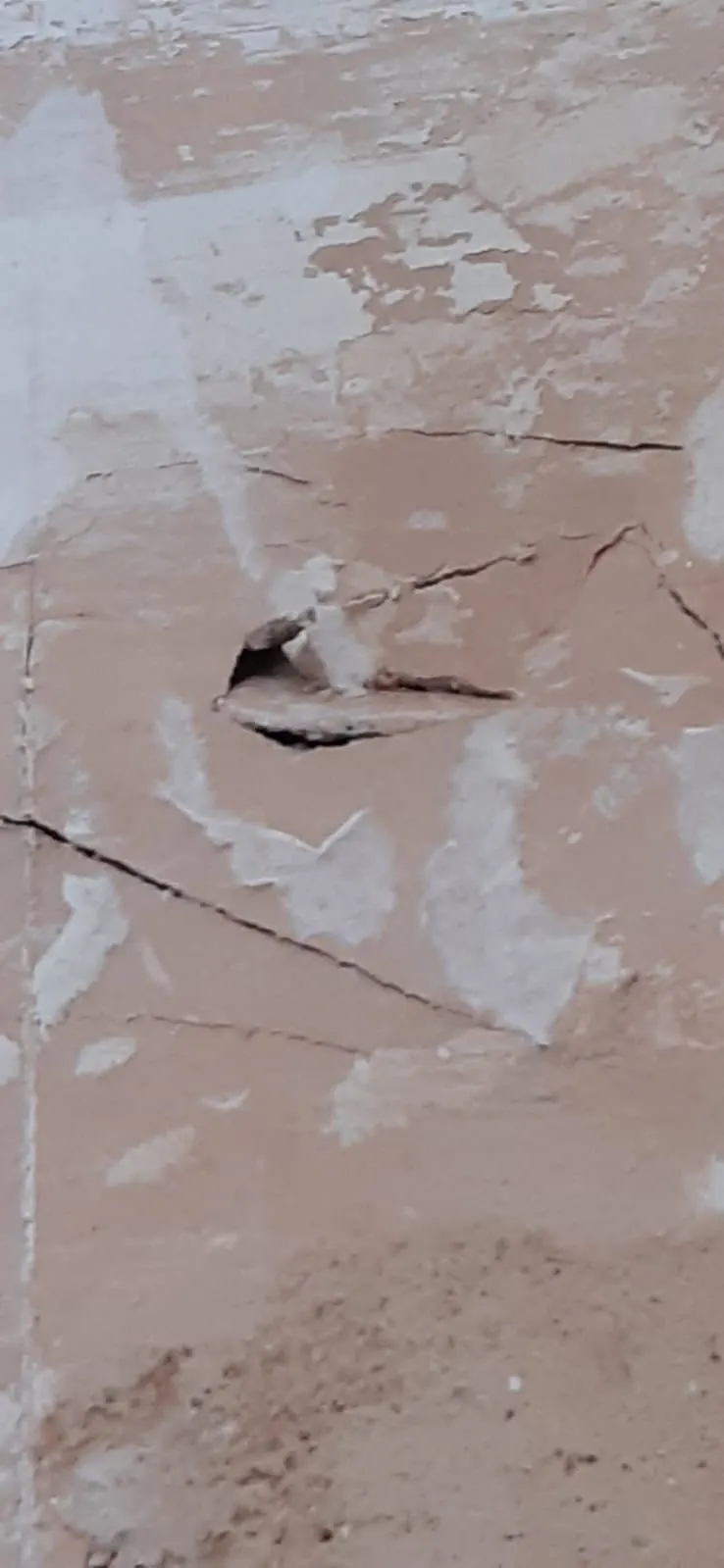 Crack and damaged plaster before wall repair