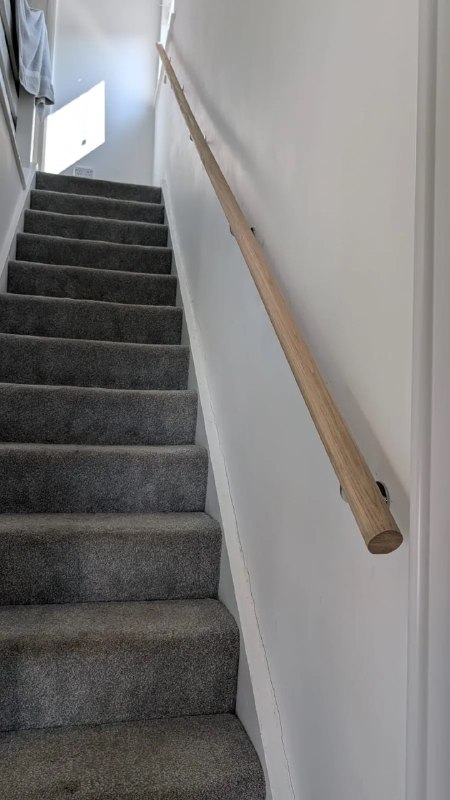 Wooden handrail installed on a staircase