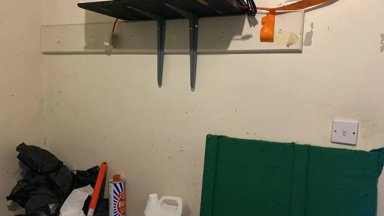 Damaged studio wall before preparation and repairs