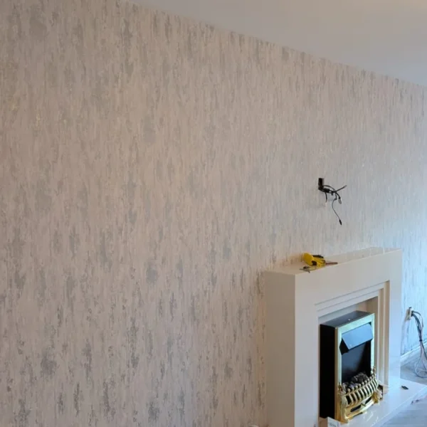Finished textured wallpaper feature wall around fireplace in Newcastle NE13